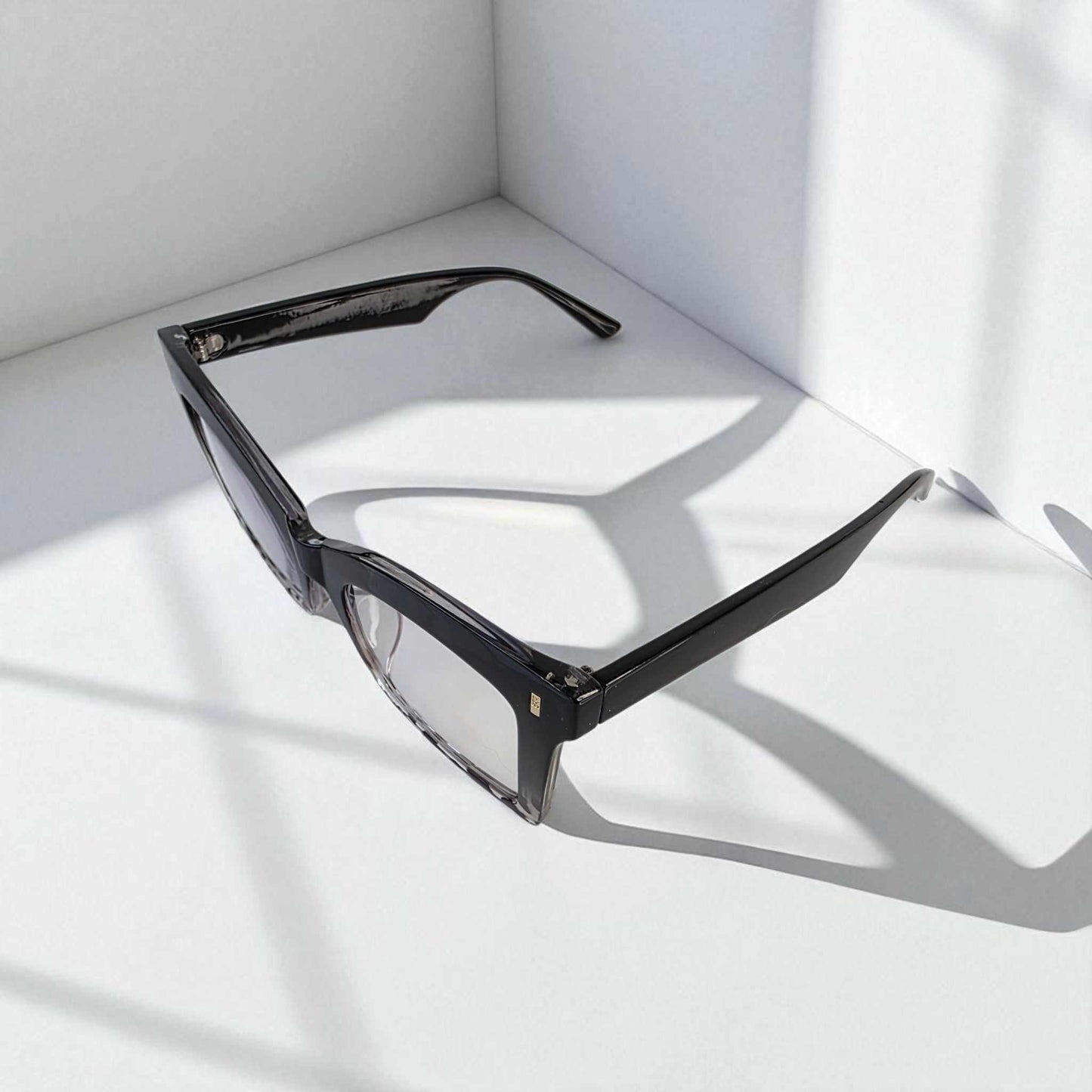 Animal print black crystal square reading glasses with blue light filter on white surface
