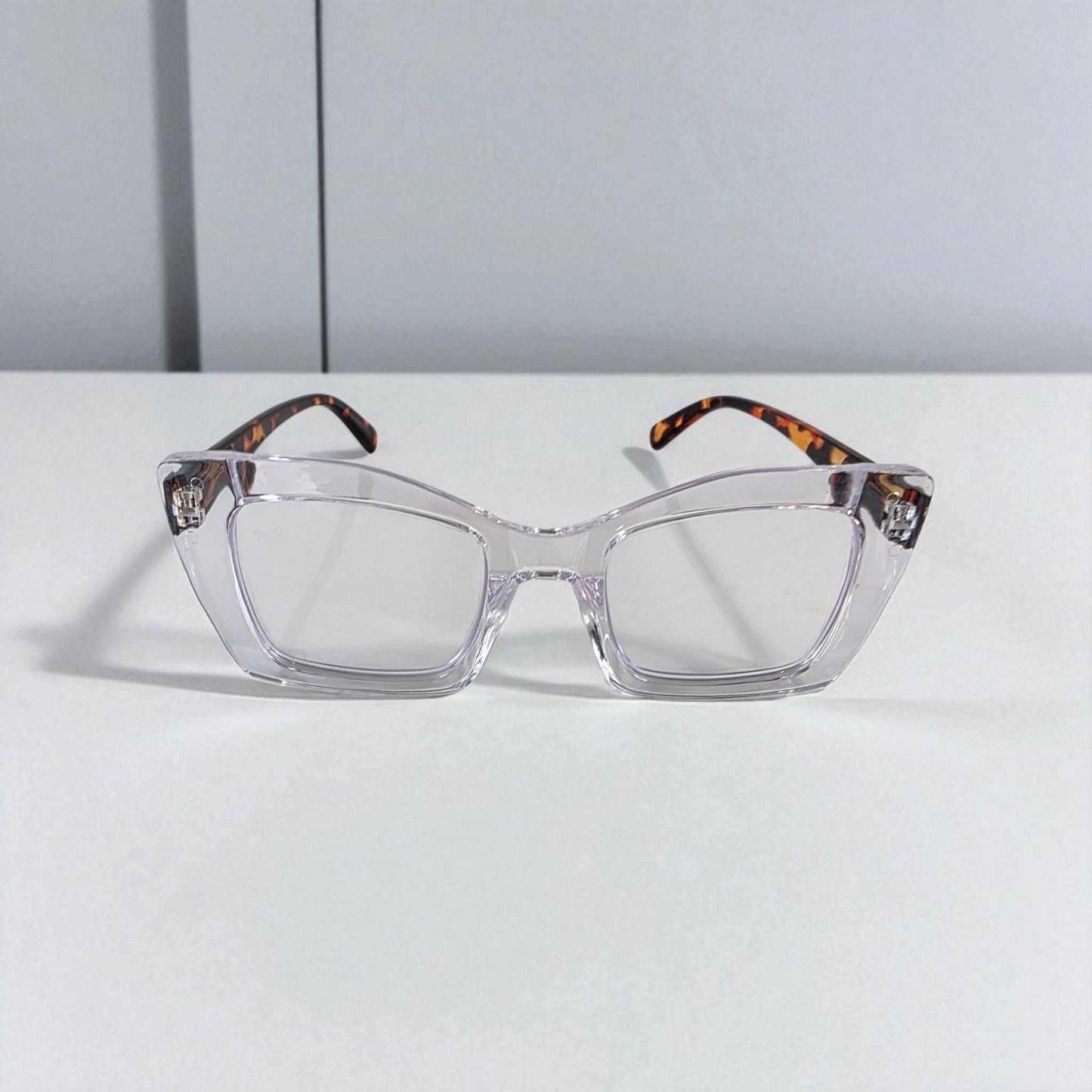 Icy Crystal Clear Tortoiseshell reading glasses with blue light filter and clear lenses on white surface