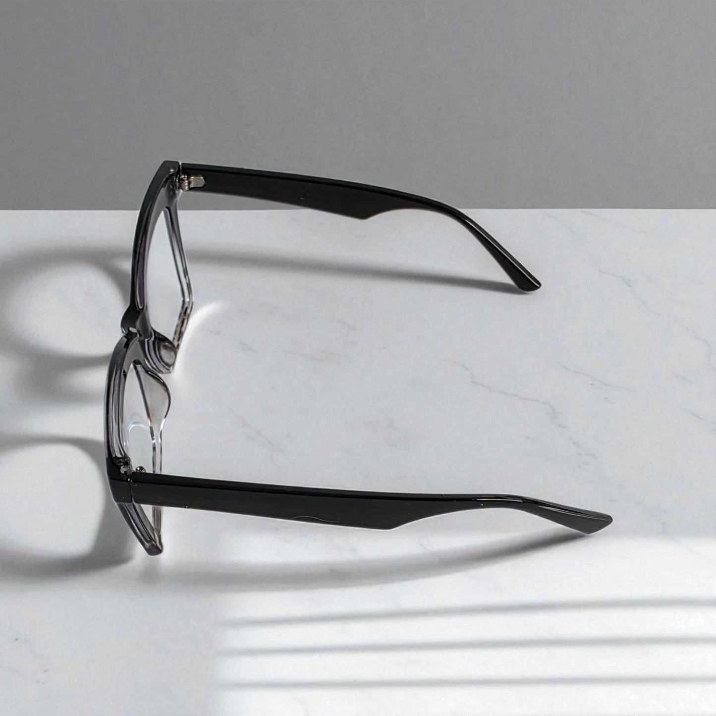 Animal Print Black crystal reading glasses with blue light filter and square frames on white marble background