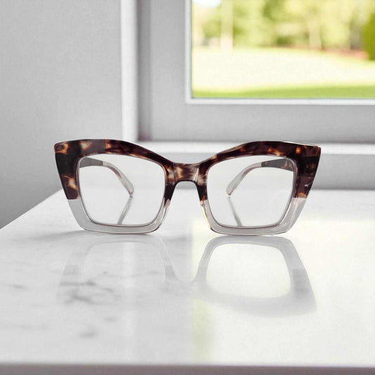 Crystal Clear Tortoiseshell Reading Glasses Crystal clear and tortoiseshell reading glasses with blue light filter on white surface by window