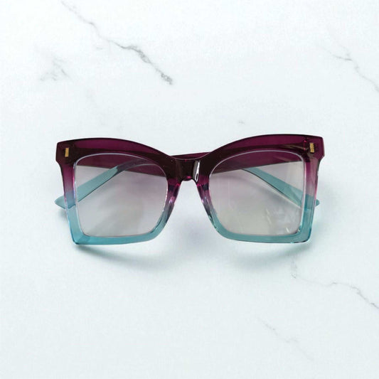 Square reading glasses with gradient purple to blue acetate frames and clear lenses with blue light filter.